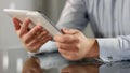 Man holding tablet in hands closeup reading news online, business application Royalty Free Stock Photo