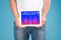 Man holding tablet with word UROLOGY on against blue background, closeup