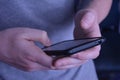 Man holding the telephone and typing message