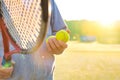 Man holding tenis racket and ball at court on sunny day