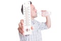 Man holding thermometer and drinking cold water Royalty Free Stock Photo