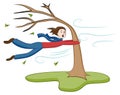 Man Holding On To Tree on Windy Day Royalty Free Stock Photo