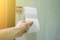Man is holding toilet paper in his hand Royalty Free Stock Photo