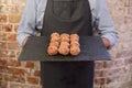 Man holding a tray of meatballs Royalty Free Stock Photo
