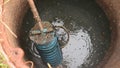 Man holding a Tuf - filter of septic system tank and water wells. Inspection and repair of household septic tank