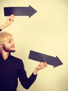 Man holding two arrows pointing same direction Royalty Free Stock Photo