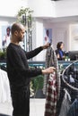 Man holding two plaid shirts in mall Royalty Free Stock Photo