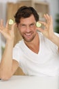 man holding two slices cucumber Royalty Free Stock Photo