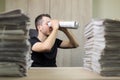 Man holding two twisted roll newspaper. Metaphor or allegory with binoculars. Selective focus on the face