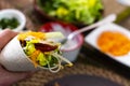 man holding typical Mexican fajita with shrimp and vegetables