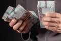 Man holding Ukrainian money 1000 hryvnia banknotes. closeup
