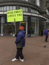 Man holding up sign saying `JESUS CHRIST LOVES YOU`