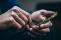 Man using a smartphone indoors. Royalty Free Stock Photo