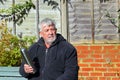 Man holding a vacuum flask and looking puzzled.