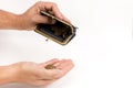 Man holding an very old wallet over an of hand with coins Royalty Free Stock Photo