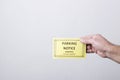 Man holding warning parking notice against white wall.Empty space for text Royalty Free Stock Photo