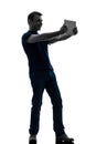 Man holding watching digital tablet silhouette Royalty Free Stock Photo