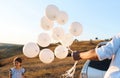 Man holding white balloons Royalty Free Stock Photo