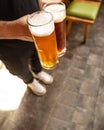 Man holding white and black beer side by side Royalty Free Stock Photo