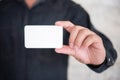 Man holding white business card on concrete wall background Royalty Free Stock Photo