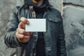 Man holding white business card on concrete wall background Royalty Free Stock Photo