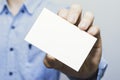 Man holding white business card on concrete wall background,mockup template Royalty Free Stock Photo