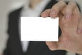 Man holding white business card,Man wearing white shirt and showing blank white business card. Blurred background. Horizontal mock