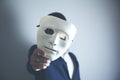 Man holding white mask for hide his face Royalty Free Stock Photo