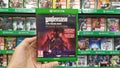 Man holding Wolfenstein Youngblood Deluxe Edition videogame on Microsoft XBOX One console in store