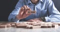 Man holding wooden block. No Debt