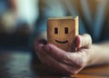 Man holding wooden block with a positive face. Concept of good rating, review and feedback. Satisfied customers. Selective focus