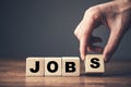 man holding wooden cubes and jobs