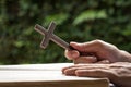 Man holding a wooden religious cross crucifix with an open bible Royalty Free Stock Photo