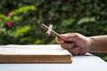 Man holding a wooden religious cross crucifix with an open bible Royalty Free Stock Photo