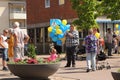 A man holding yellow and blue balloons on the celebration of Swedens national day.