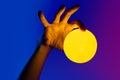 Man holding yellow moon shape illuminated sphere