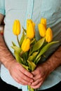 Man holding yellow tulips. Mothers day, Womens day concept.