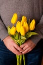 Man holding yellow tulips. Mothers day, Womens day concept.