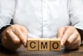 Man holds abbreviation CMO. Marketing strategy of the company. Post top manager Chief Marketing Officer. PR and advertising