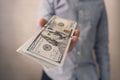 a man holds American dollars in his hand. The boss pays the salary. The concept of bribery and corruption, giving money Royalty Free Stock Photo