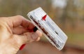 A man holds an audiotape on a ballpoint pen