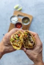 Man holds authentic mexican tacos with pork meat and vegetables Royalty Free Stock Photo