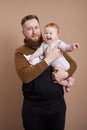 Man holds a baby in his arms. Portrait of a young father after the birth of a child. Young family Royalty Free Stock Photo