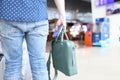 Man holds bag with a passport and tickets in his hand while standing at airport Royalty Free Stock Photo