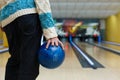 Man holds ball at bowling lane, cropped image Royalty Free Stock Photo