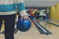 Man holds ball at bowling lane, cropped image Royalty Free Stock Photo