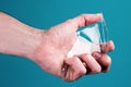 Man holds broken, broken smartphone safety glass in hand on blue background. concept fragile equipment