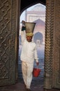 Man holds a bucket at Masjid Jama, Old Delhi, India Royalty Free Stock Photo
