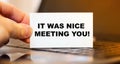 A man holds a business card with the words IT WAS NICE MEETING YOU Royalty Free Stock Photo