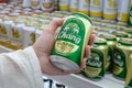 Man holds a can of popular Thai beer Chang in his hand